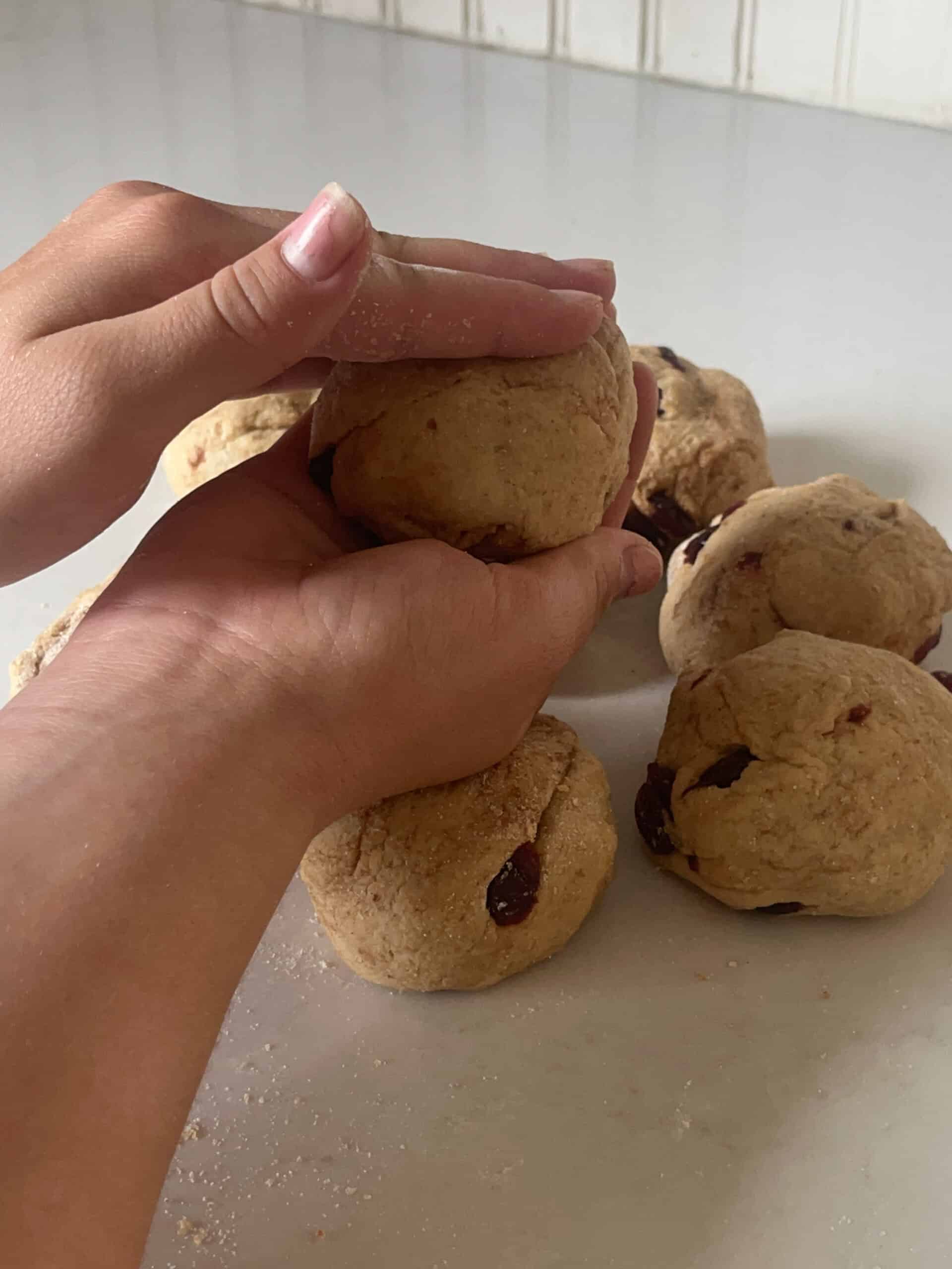 Rolling bagel dough into balls.